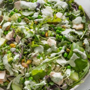 Green goddess salad in a large speckled ceramic bowl.