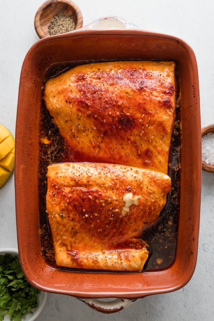 Baked salmon sprinkled with paprika and surrounded by a honey lime soy sauce mixture.