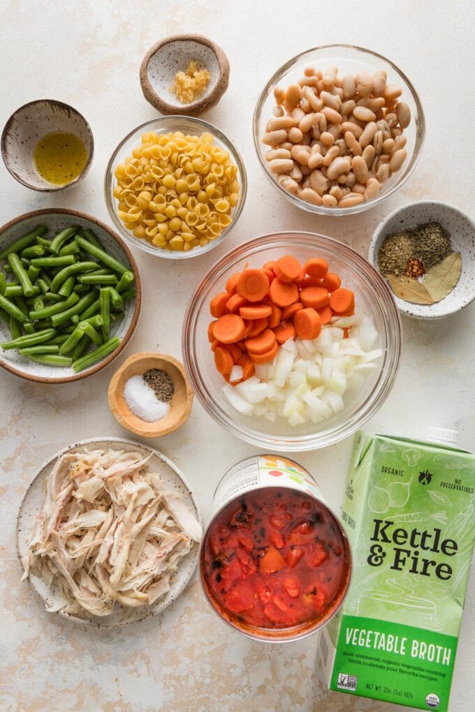 Overhead photo of the ingredients needed to make an easy minestrone soup with chicken mixed in.
