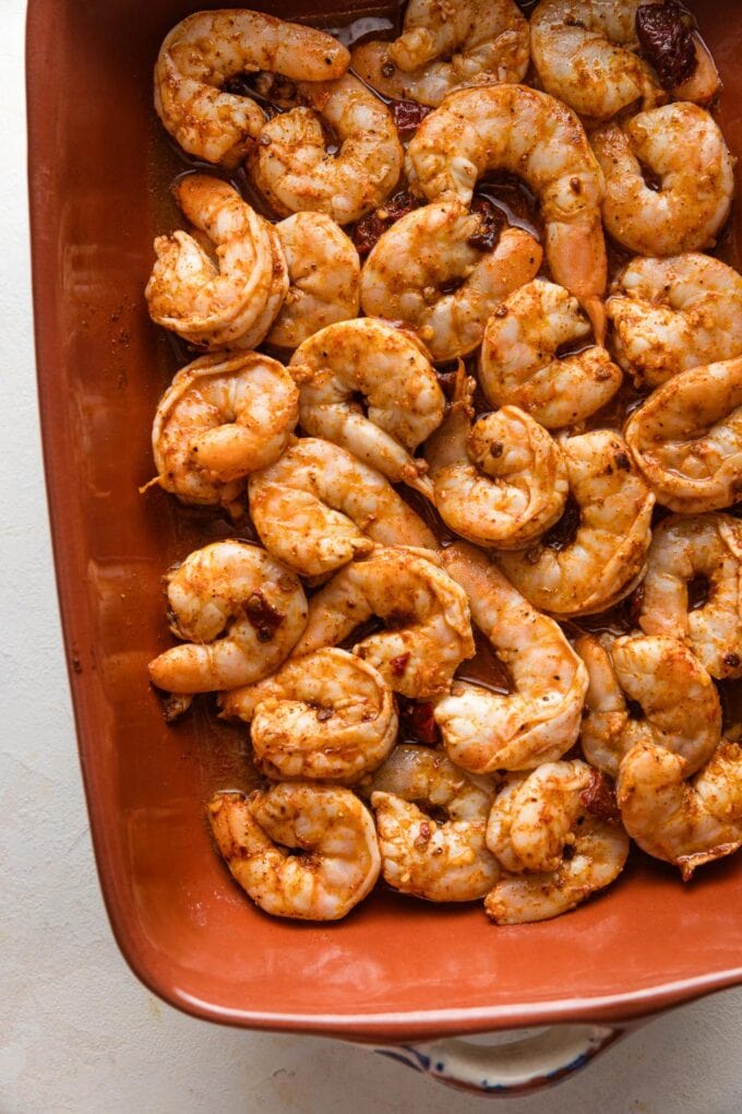 Cooked chipotle seasoned shrimp in a baking pan.