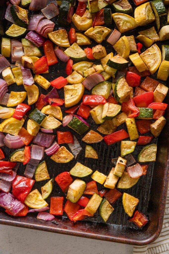 Roasted summer veggies on a baking tray.