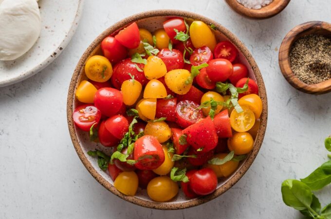 Cherry tomatoes cut in half and tossed with olive oil, salt, pepper, and basil.