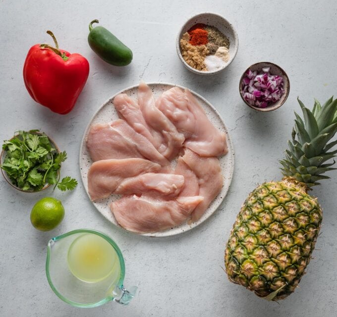 Overhead view of ingredients for a brown sugar spice rub chicken dish with pineapple pepper salsa.