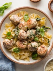 Bowl full of pasta with chicken Florentine meatballs.