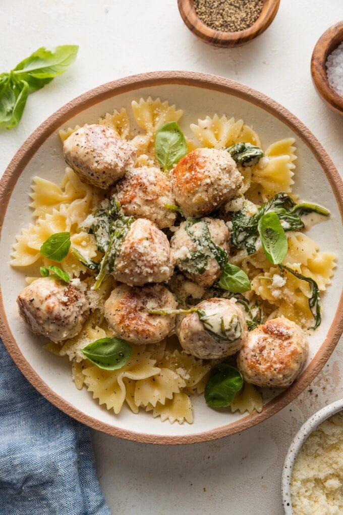 Bowl full of pasta with chicken Florentine meatballs.
