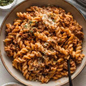 Bowl of easy rotini pasta with tomato sauce and Parmesan.