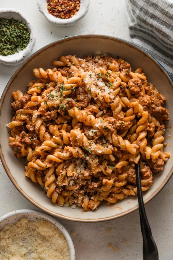 Bowl of easy rotini pasta with tomato sauce and Parmesan.