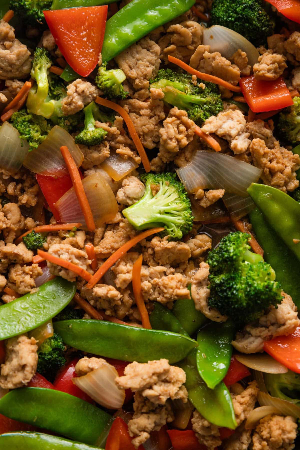 Close up of a ground chicken and veggie stir fry showcasing the glossy homemade sauce.