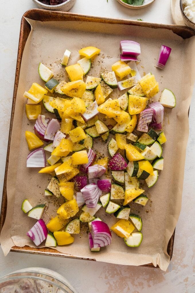 Veggies chopped and piled on a sheet pan.