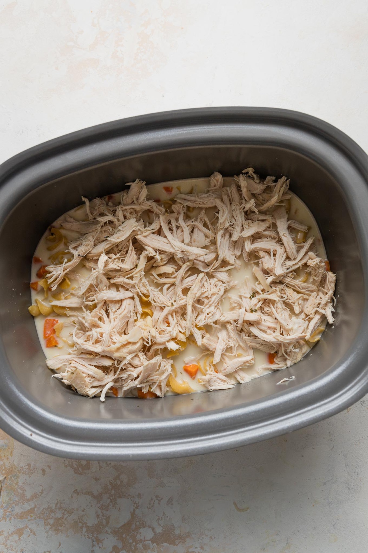 Shredded chicken added back to slow cooker to warm through.