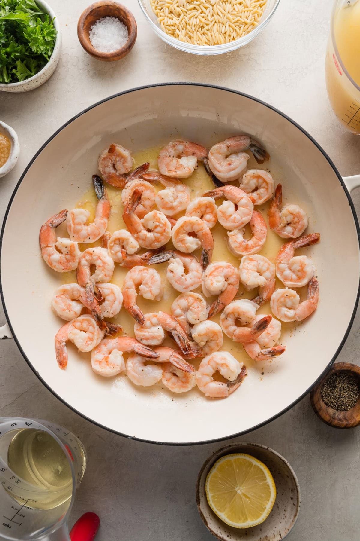 Shrimp sauteed in an enameled cast iron skillet.