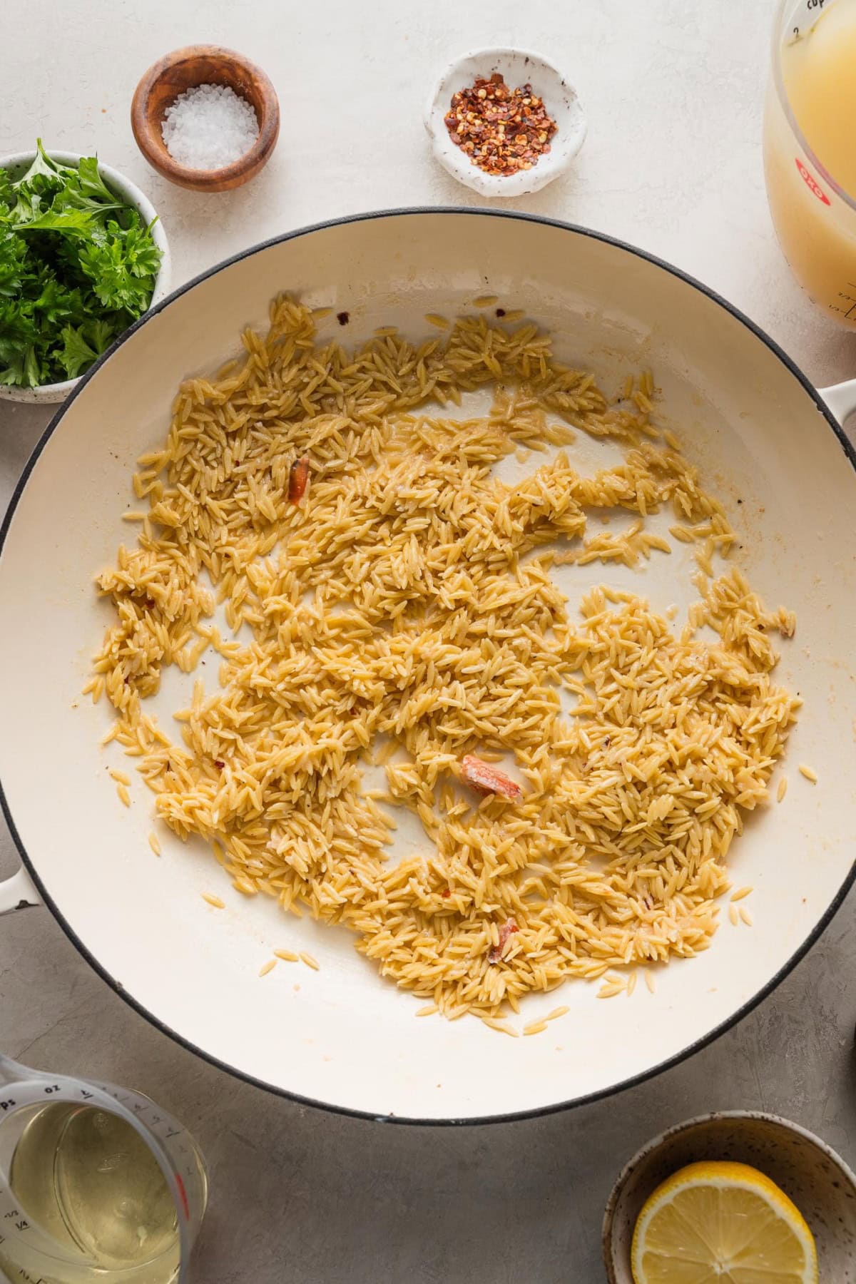 Orzo toasted in a skillet.