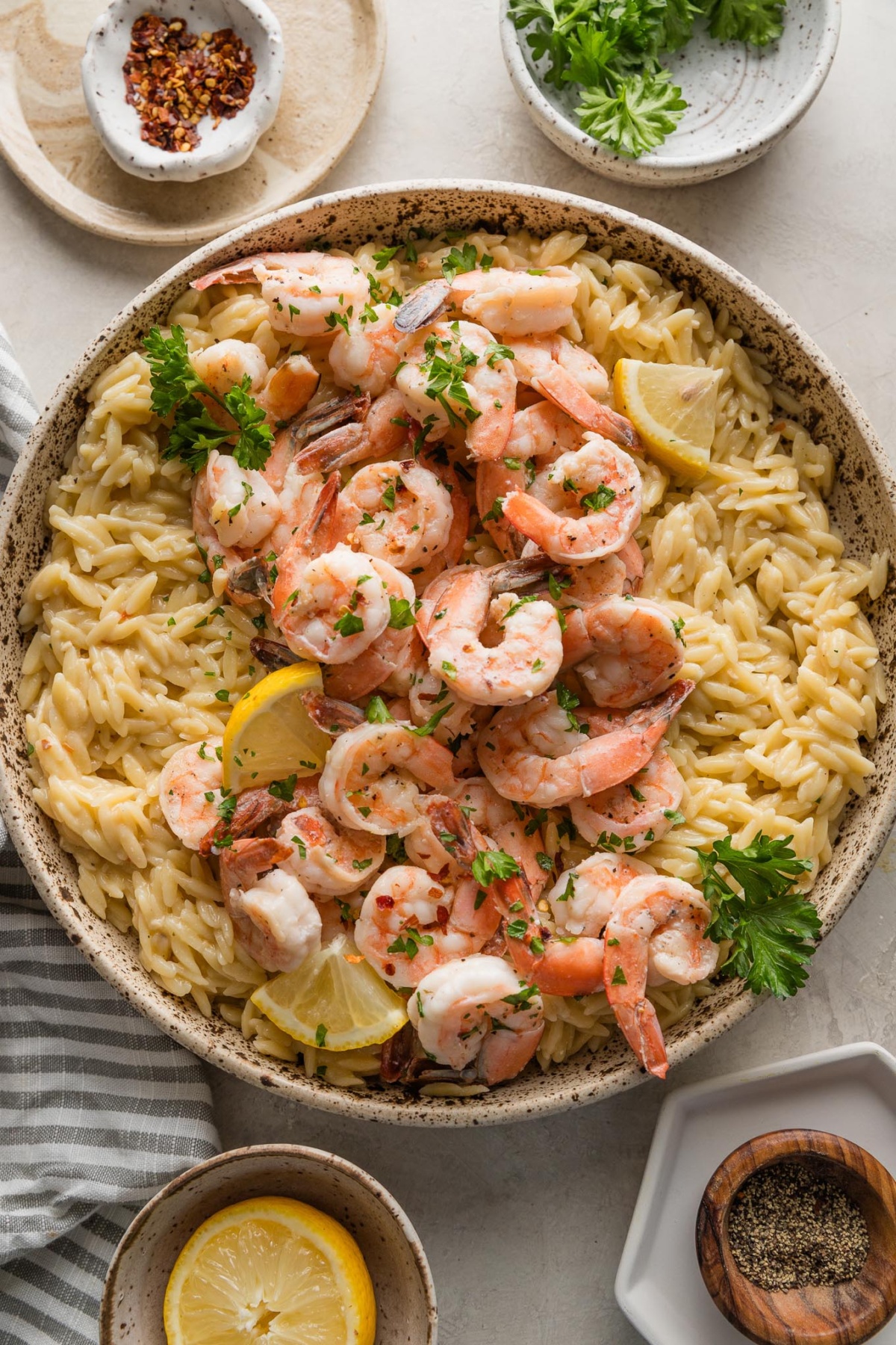 Countertop set with a serving bowl full of shrimp scampi.