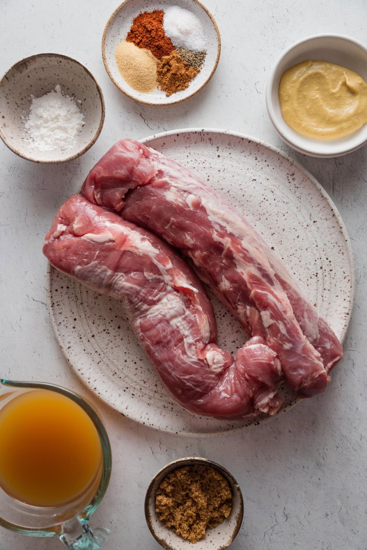 Overhead of ingredients for apple cider pulled pork made from two tenderloins.
