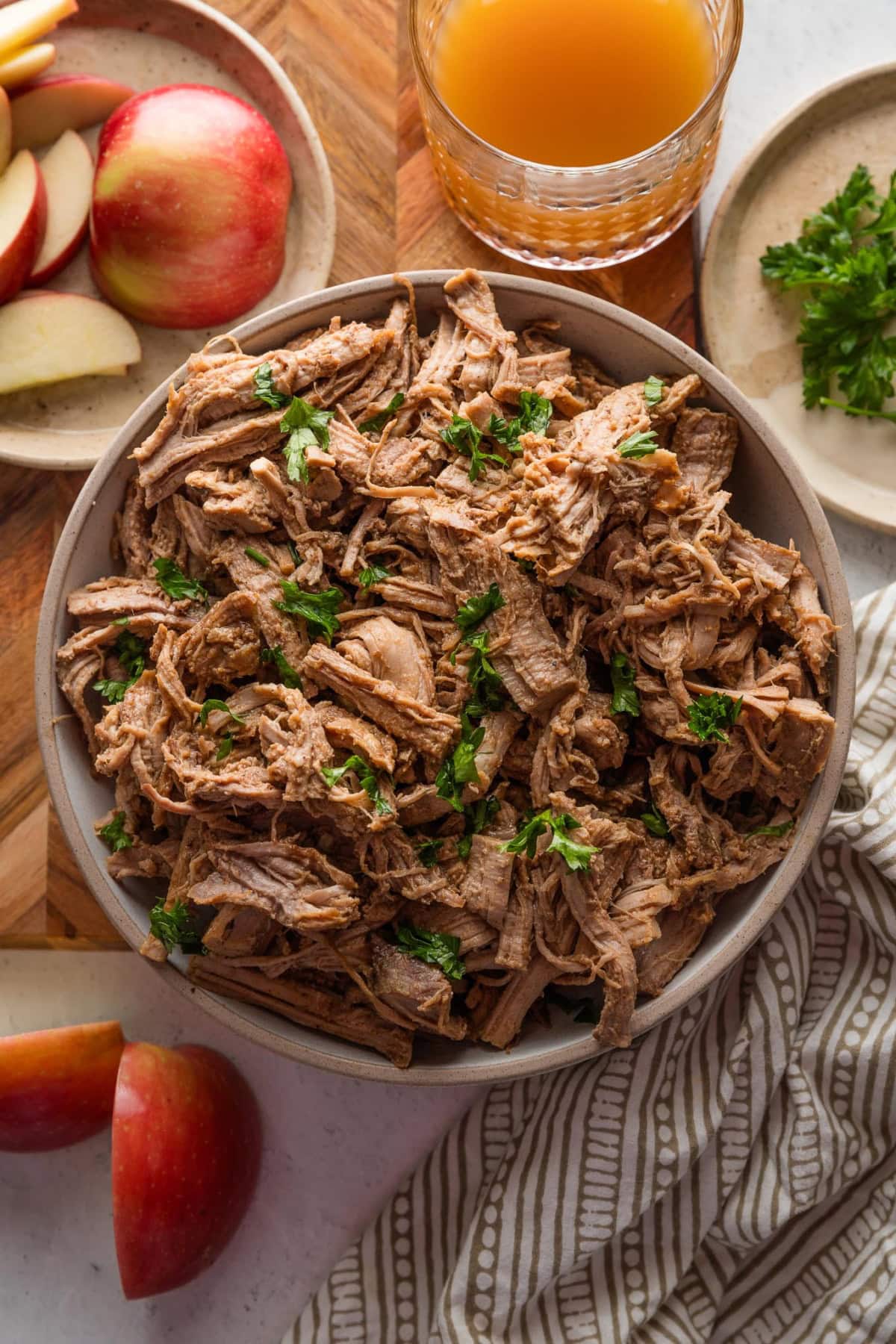 Serving bowl filled with apple cider pulled pork.